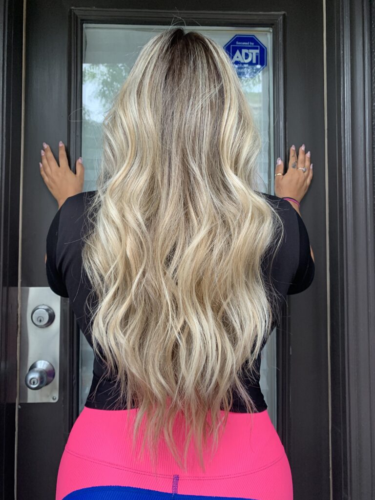 Photo of a balayage hair transformation at Tatiana Hair Toronto salon. The result reveals soft, hand-painted highlights for a naturally blended, sun-kissed look.